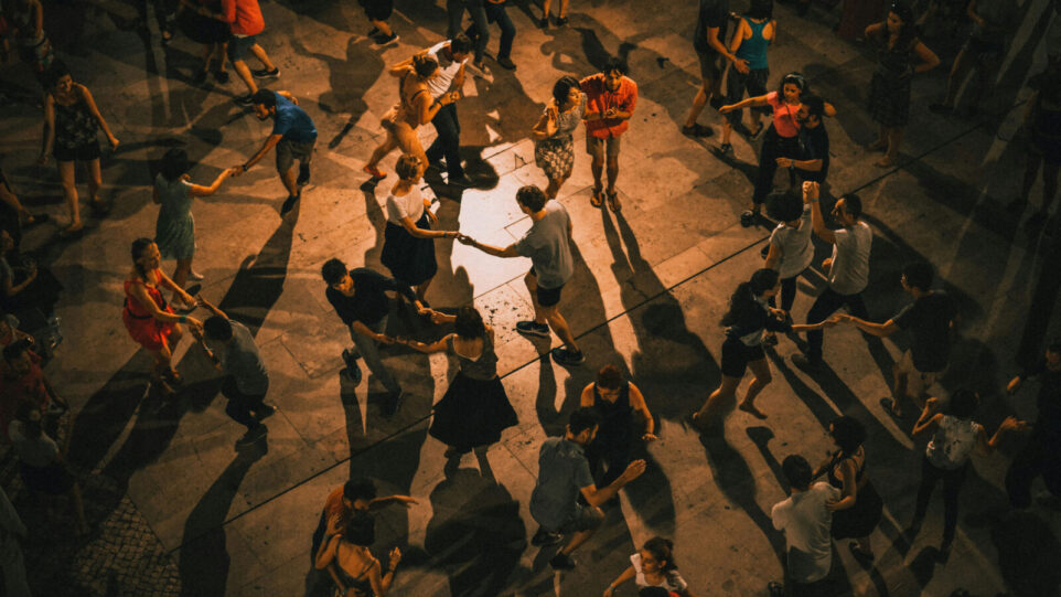 People in a circular pattern dancing together