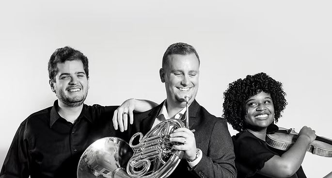 Members of the Black Moon Trio pose with their instruments