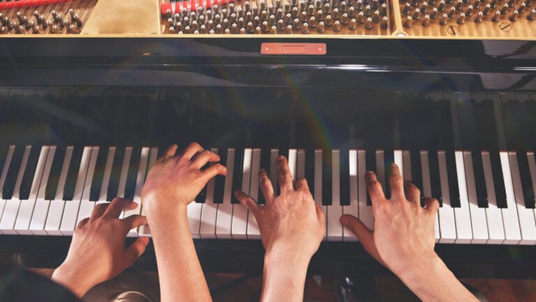 Overhead shot of two pianists playing piano four hands