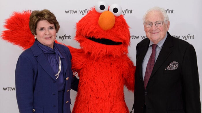 Fay and Daniel Levin pose with Elmo at a WTTW-WFMT event