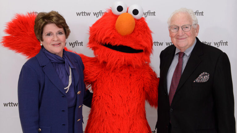 Fay and Daniel Levin pose with Elmo at a WTTW-WFMT event