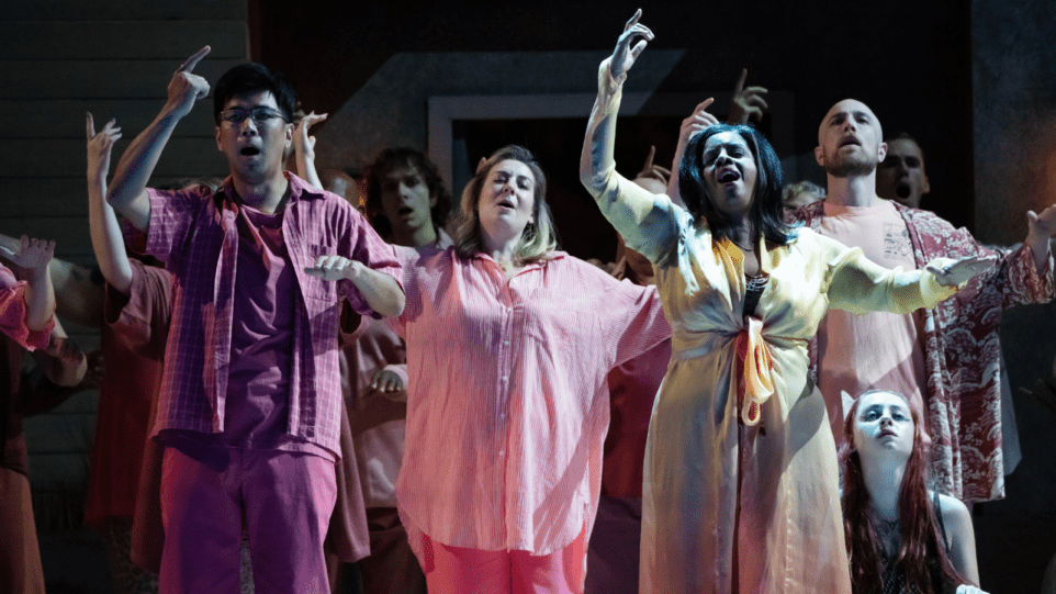Multiple figures in pink, fuchsia, or rose colored casual attire, seeming to be dancing in a reverie with their right arms gesturing upwards.