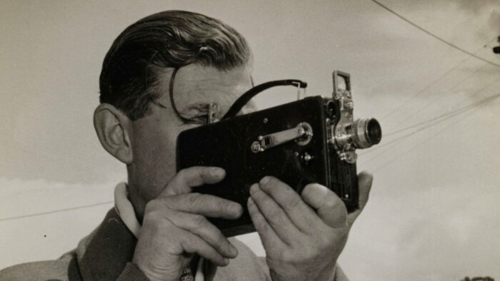 Man with Vintage Film Camera lining up a shot for a moving picture