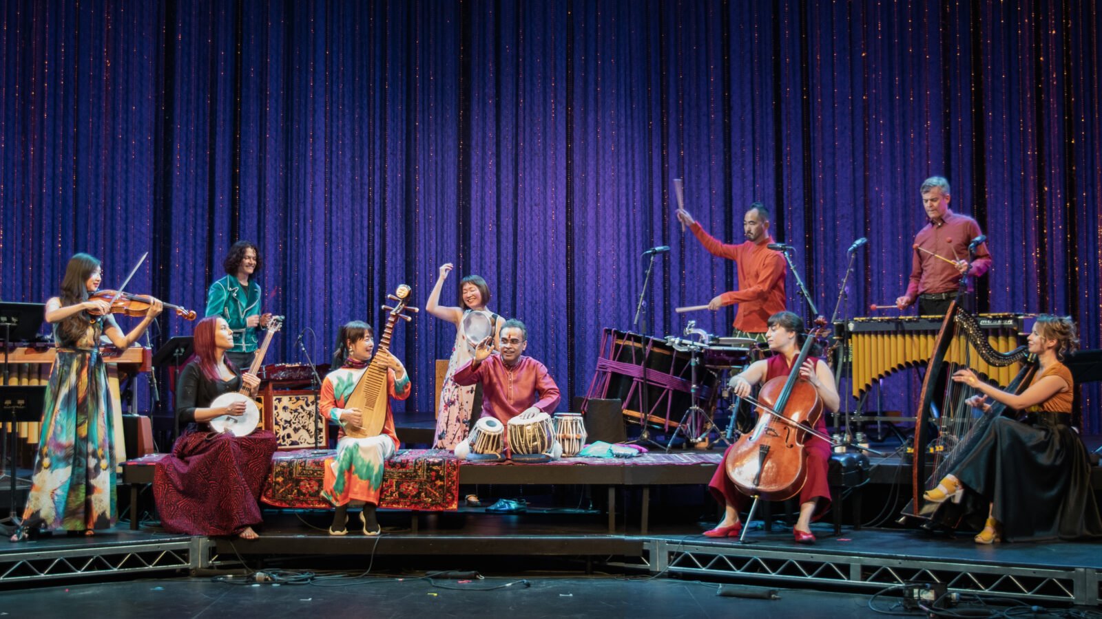 A group of musicians perform onstage