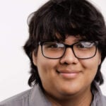 Young man with glasses and longish black hair