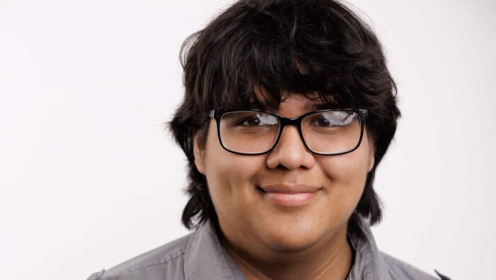 Young man with glasses and longish black hair