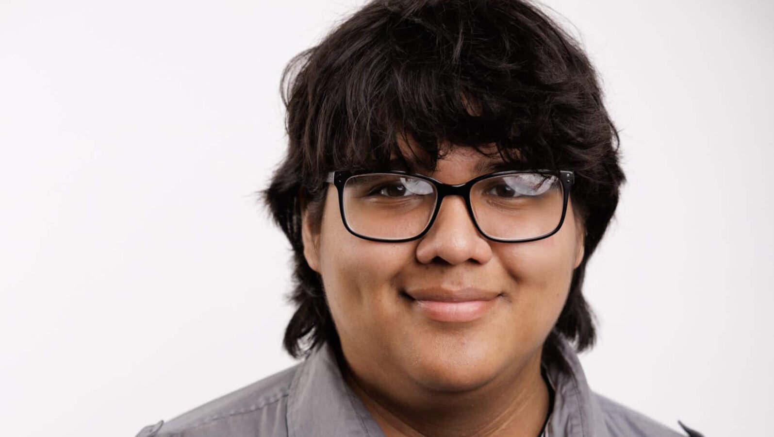 Young man with glasses and longish black hair
