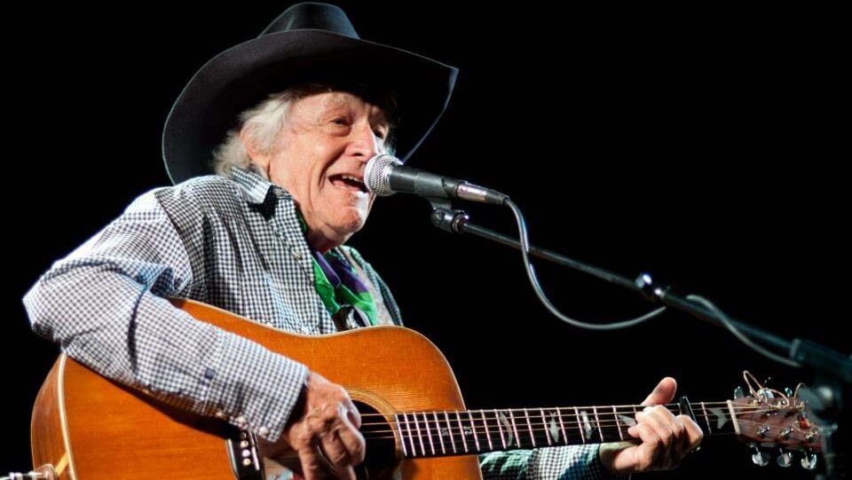 man in cowboy hat playing guitar