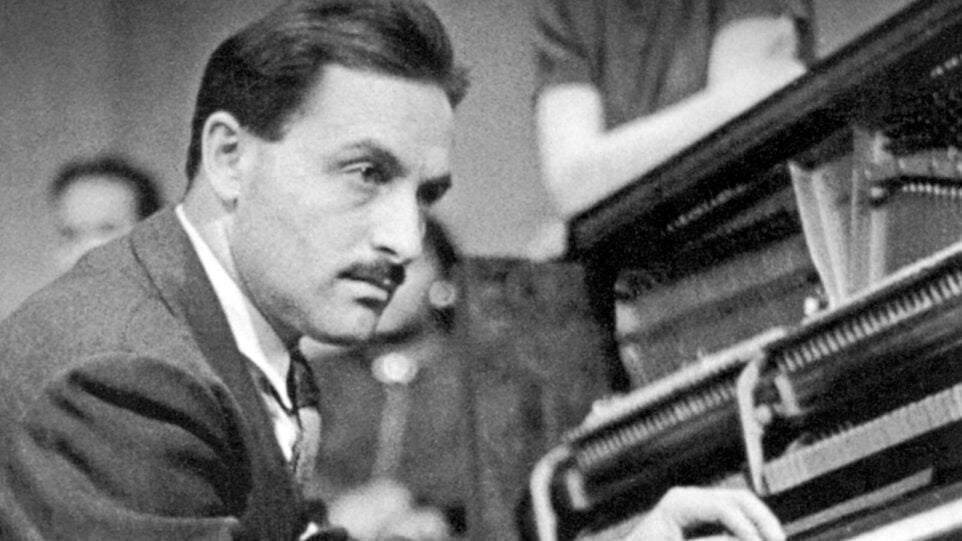 Man sits pensively at keyboard