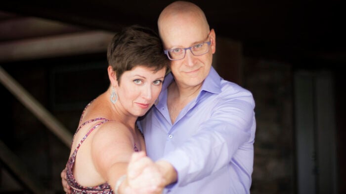 dancing man and woman look into camera