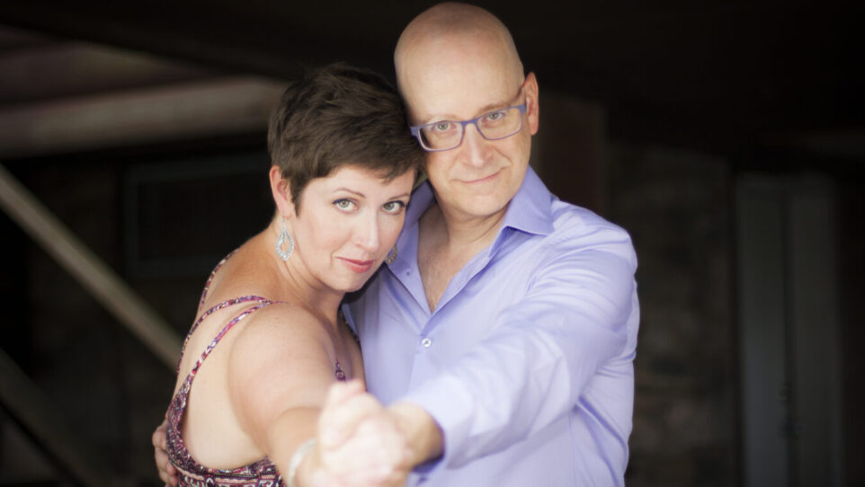 dancing man and woman look into camera