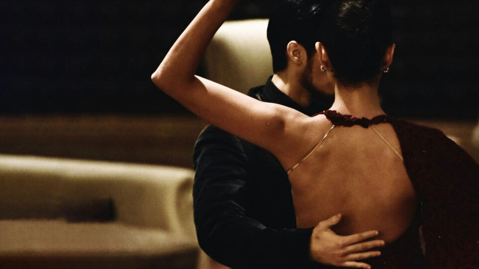 Two dancing the Tango, in a dark restaurant