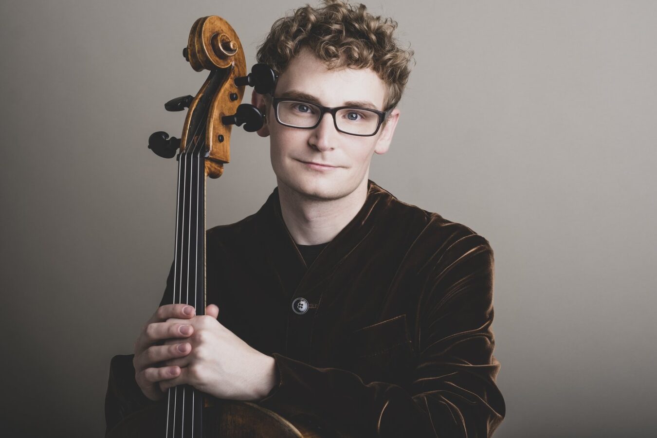 Cellist Alexander Hersh posing with his cello