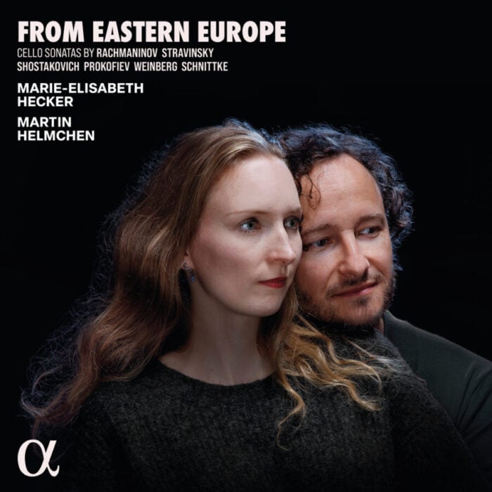 two artists in front of black background