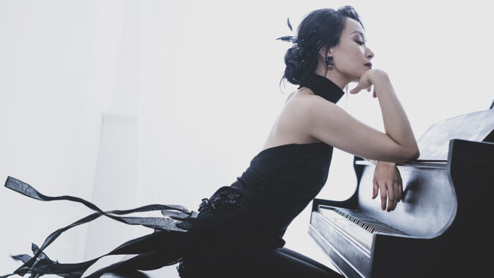 Woman in a black dress at the piano