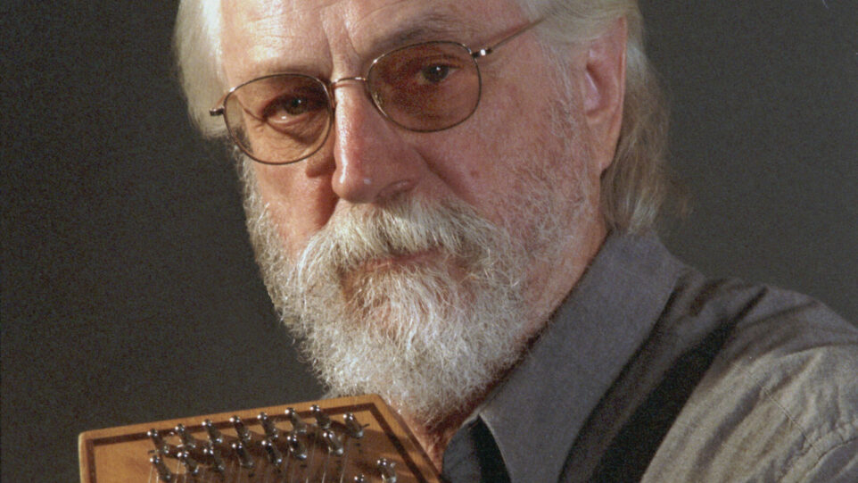 bearded man looks into camera