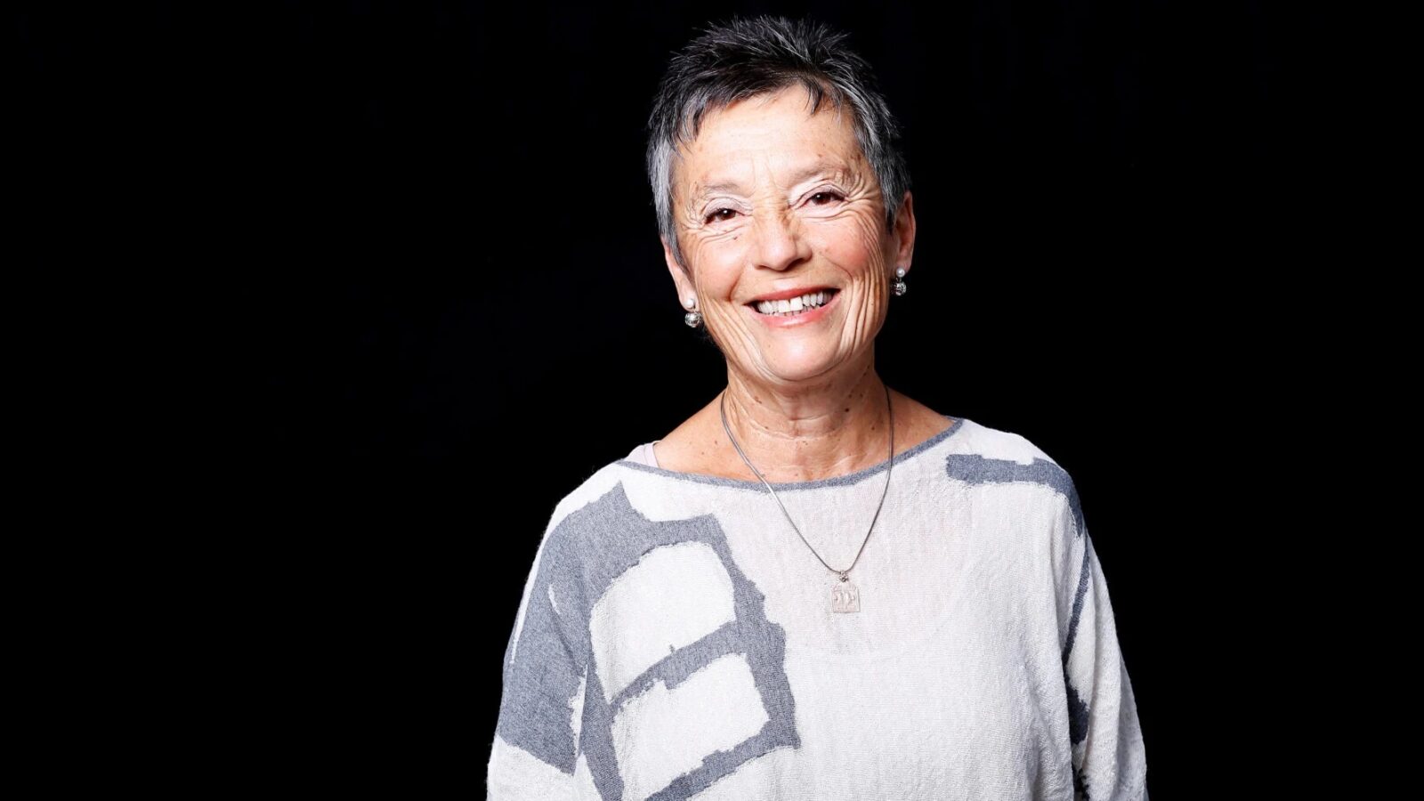 Woman in blouse against black background