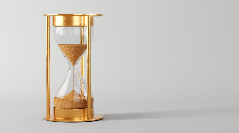 gold leaf hourglass with sand halfway depleted