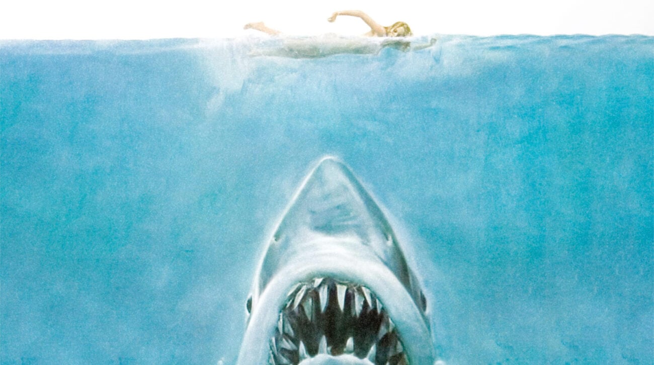 closeup of Jaws poster features woman swimming in open water... with shark lurking below