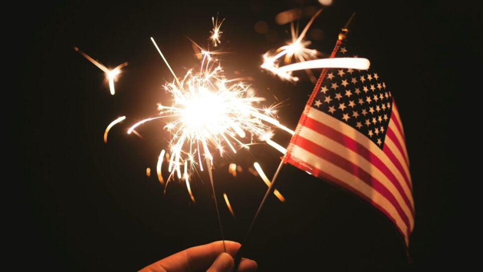 A sparkler and an American flag