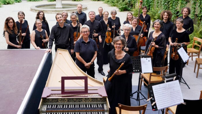 group of musicians pose with early instruments