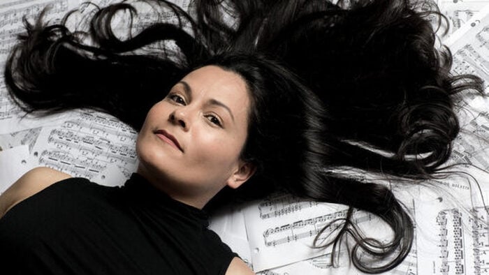 woman laying on sheet music
