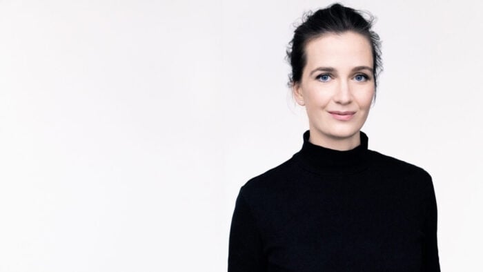 Woman in dark turtleneck white background