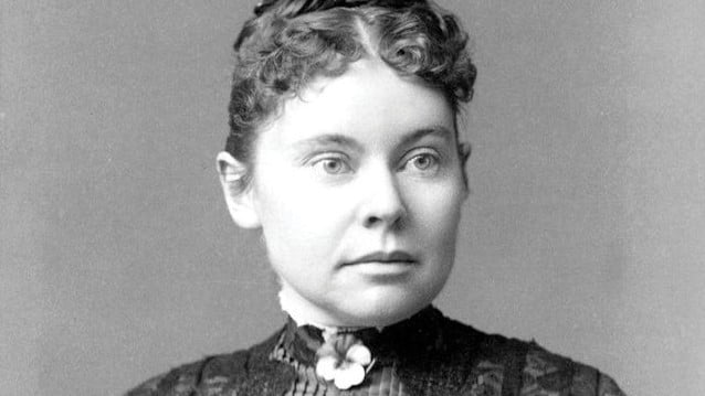 black and white photo of woman with tightly curled hair wearing a high collar