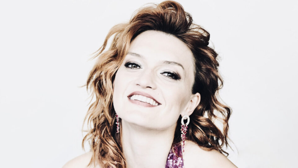 Smiling dark redhaired woman woman in pink dress