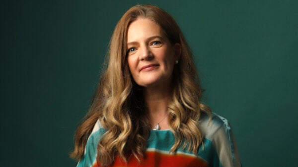 Woman in front of turquoise background