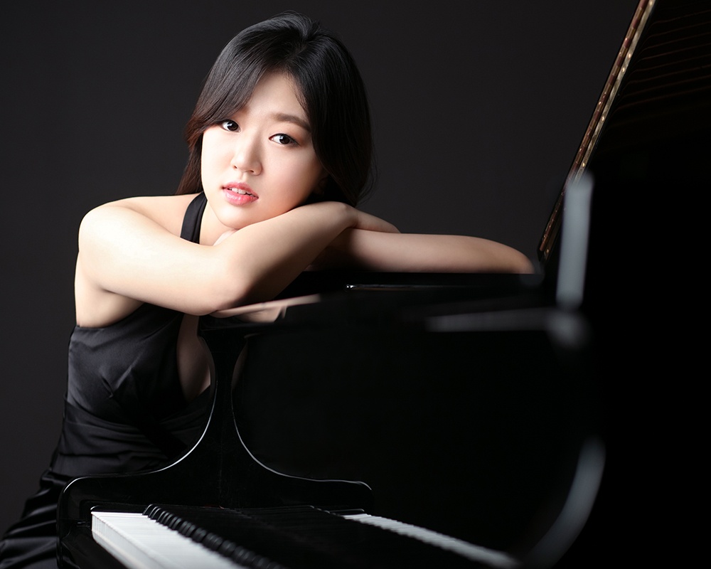 Seoyun Baek sits at the piano