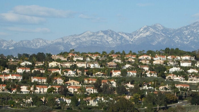 rows of suburban homes with mountains in background