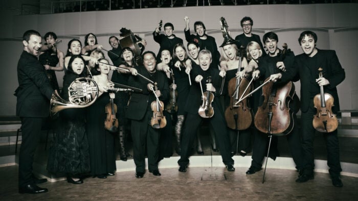 group of musicians posing playfully