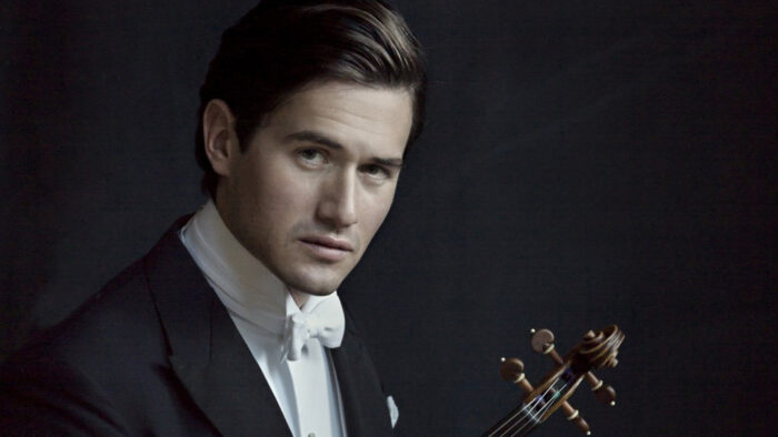 man in white tie holds violin