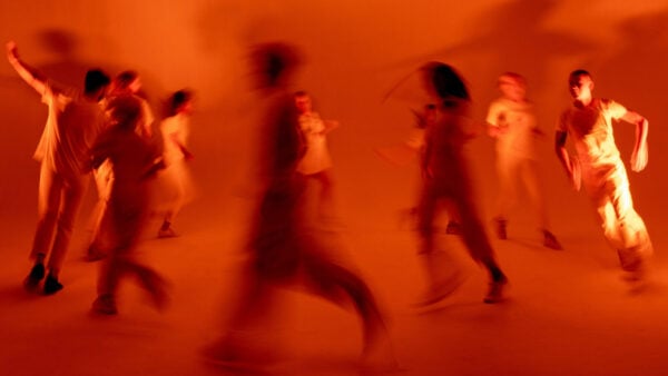 Martha Graham and her Music Orange Room of Dancers in a circle with a bit of motion blur