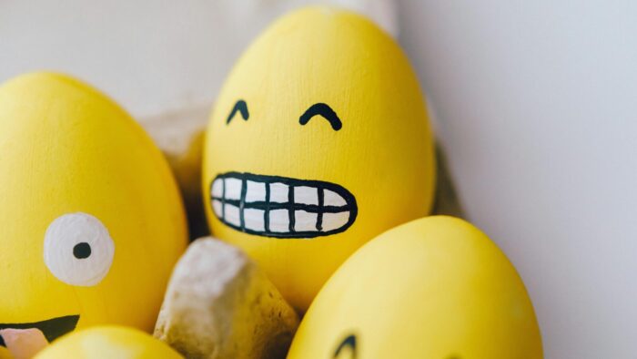 Yellow painted egg with a smiley emoticonn