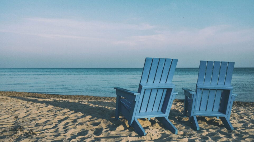 Two chairs at the beach enjoying the view