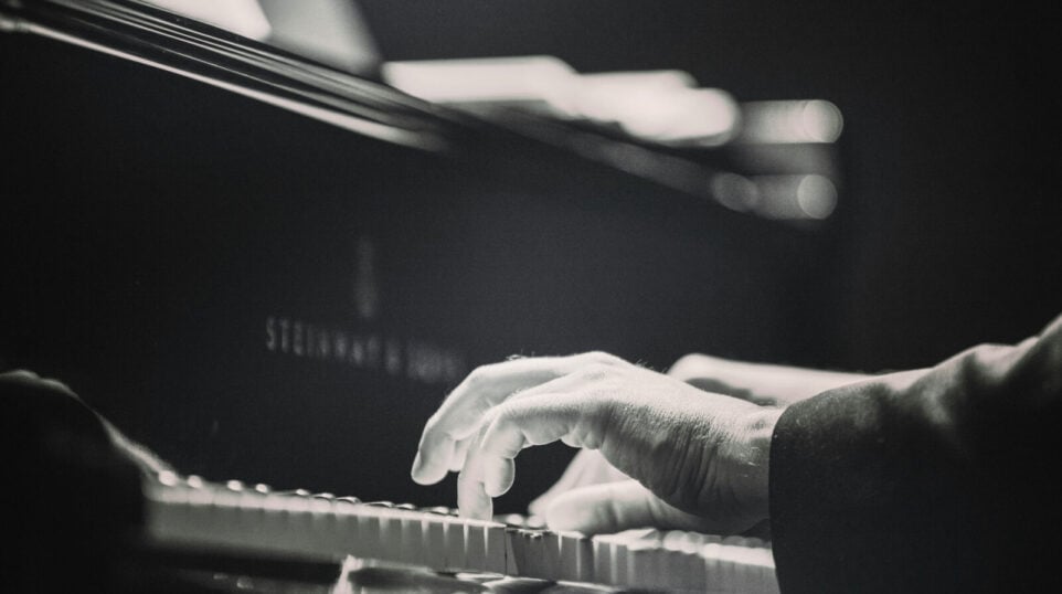 Black and White photo playing the piano
