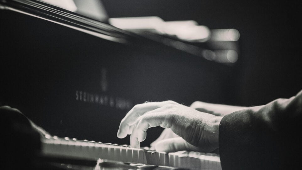 Black and White photo playing the piano