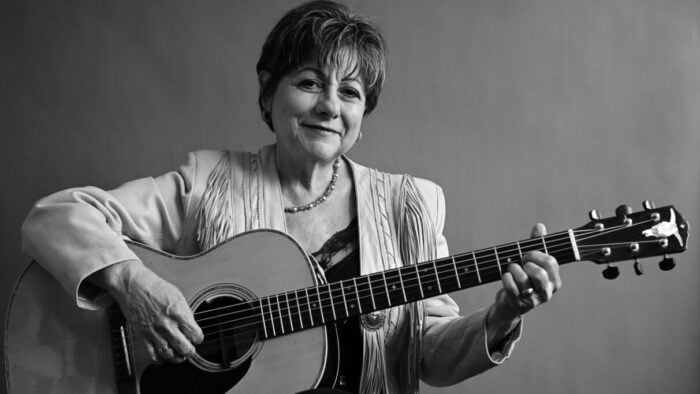 smiling older woman with guitar