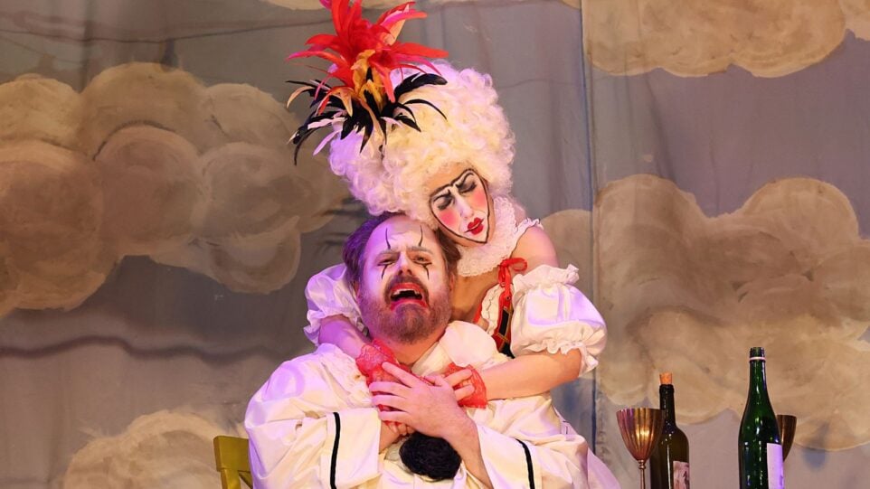 Performance photo if Pagliacci. Michelle Allie Drever as Nedda in Columbina costume embracing a crying Jonathan Burton as Canio in Pierrot costume.