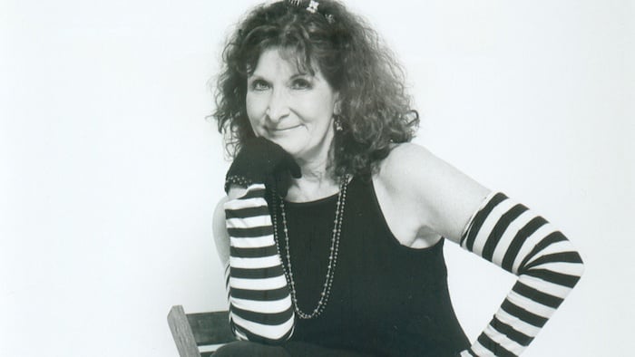 smiling woman looks into camera