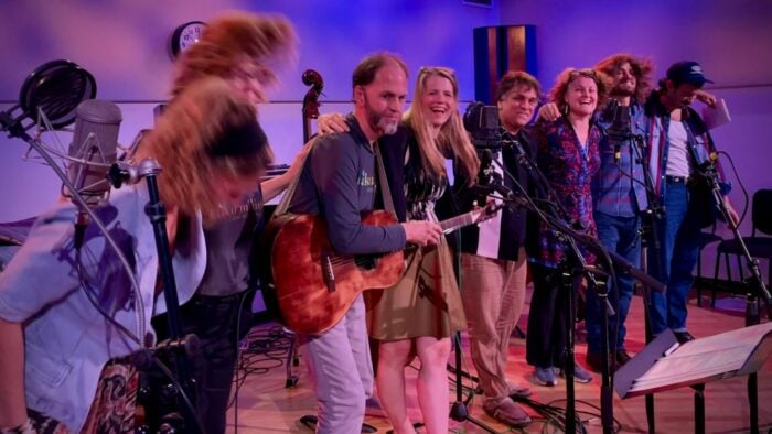 several musicians in a line taking a bow